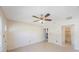 Open living space showcasing tile floors, a ceiling fan, and views of the kitchen and bathroom at 6711 3Rd N St, St Petersburg, FL 33702