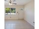 Neutral living area with tile floors, a ceiling fan, and a white door at 6711 3Rd N St, St Petersburg, FL 33702