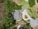 Aerial view of a charming home with a pool, set amidst lush landscaping and a unique driveway at 10905 Elliot St, Riverview, FL 33578