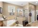 Well-lit bathroom features a tub with tile surround and a glass enclosed shower stall at 10905 Elliot St, Riverview, FL 33578