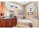 Bright primary bathroom offering a large soaking tub and a luxurious vanity area at 10905 Elliot St, Riverview, FL 33578
