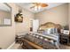 Comfortable bedroom with a mounted TV, a wooden bed frame, and neutral colored walls at 10905 Elliot St, Riverview, FL 33578