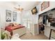 This bedroom features a ceiling fan, a TV and an open walk-in closet at 10905 Elliot St, Riverview, FL 33578