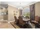 Formal dining room featuring elegant chandelier, large window with lots of natural light, and seating for six at 10905 Elliot St, Riverview, FL 33578