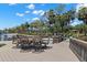 Waterfront dock featuring an outdoor dining set, boat lifts, and scenic views of the water and lush greenery at 10905 Elliot St, Riverview, FL 33578