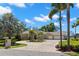 Beautiful single-story home with a circular brick driveway and lush tropical landscaping at 10905 Elliot St, Riverview, FL 33578