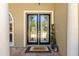 Elegant glass front doors, set on brick, welcome you into the home at 10905 Elliot St, Riverview, FL 33578