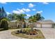 Lovely single-level home boasts mature palms, verdant foliage, and circular driveway at 10905 Elliot St, Riverview, FL 33578