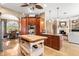 Open-concept kitchen boasts custom cabinets, modern appliances, and island, seamlessly flowing into the dining and living areas at 10905 Elliot St, Riverview, FL 33578