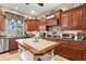 Gourmet kitchen featuring custom cabinetry, granite countertops, and an oversized center island with a stone top at 10905 Elliot St, Riverview, FL 33578