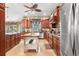 Well-appointed kitchen with rich wood cabinets, granite countertops, and center island at 10905 Elliot St, Riverview, FL 33578