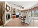 Cozy living area with fireplace, built-in shelving, and views to the pool at 10905 Elliot St, Riverview, FL 33578
