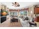 Bright living room features plush seating, a ceiling fan, and access to outdoor views at 10905 Elliot St, Riverview, FL 33578