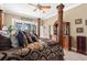 A cozy primary bedroom with a decorative bed and a view of the lake and lanai at 10905 Elliot St, Riverview, FL 33578
