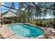 Inviting screened-in pool area with a water feature and brick-paved deck, great for relaxation at 10905 Elliot St, Riverview, FL 33578