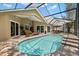 Gorgeous screened-in pool with a seating area, surrounded by a brick-paved patio at 10905 Elliot St, Riverview, FL 33578