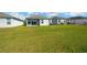 Sprawling green backyard of home with pond in distance at 11221 Gold Compass St, Gibsonton, FL 33534