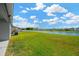 Expansive backyard with lush green grass extending to a serene pond at 11221 Gold Compass St, Gibsonton, FL 33534