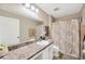 Neutral bathroom featuring large mirror, single vanity, shower and toilet at 11221 Gold Compass St, Gibsonton, FL 33534