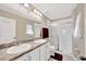 Bright bathroom featuring double sinks, a large mirror, and a glass-enclosed shower at 11221 Gold Compass St, Gibsonton, FL 33534