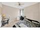 Bedroom featuring a ceiling fan, a bed, desk, and a bedside table at 11221 Gold Compass St, Gibsonton, FL 33534
