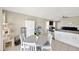 Cozy dining area with white table and chairs, adjacent to the kitchen, offering comfortable seating at 11221 Gold Compass St, Gibsonton, FL 33534