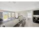 Open kitchen with granite countertops and an island, featuring a bright dining area and backyard views at 11221 Gold Compass St, Gibsonton, FL 33534