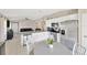 Bright kitchen with stainless steel appliances, white cabinetry, granite countertops, and dining table at 11221 Gold Compass St, Gibsonton, FL 33534