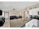 Modern kitchen with granite countertops, stainless steel appliances, and seamless flow into the living room at 11221 Gold Compass St, Gibsonton, FL 33534