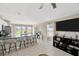 Bright, open living space with a large island, seating, and a view of the backyard and adjacent living room at 11221 Gold Compass St, Gibsonton, FL 33534