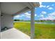 Covered patio overlooking a spacious backyard and a scenic pond at 11221 Gold Compass St, Gibsonton, FL 33534