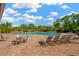 Community pool with ample seating and well-maintained landscaping for a relaxing environment at 11221 Gold Compass St, Gibsonton, FL 33534
