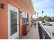 Apartment balcony with black railings offering views of the street and nearby buildings at 121 46Th Ave # 2H, St Pete Beach, FL 33706