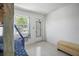 Bright bedroom with terrazzo floors, natural light, and stylish chevron bench seating at 121 46Th Ave # 2H, St Pete Beach, FL 33706
