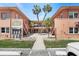 Charming condo complex exterior with lush landscaping, palm trees, and well-maintained grounds in a sunny setting at 121 46Th Ave # 2H, St Pete Beach, FL 33706