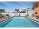 Inviting community pool with lounge chairs and tables perfect for relaxation and socializing in a Florida condo complex at 121 46Th Ave # 2H, St Pete Beach, FL 33706