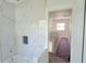 Bathroom featuring white marble tile, modern soaking tub, and new construction at 1405 50Th N Ave, St Petersburg, FL 33703