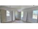 Spacious bedroom with light hardwood floors and large windows bringing in natural light at 1405 50Th N Ave, St Petersburg, FL 33703