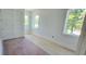 Bright bedroom with white walls, hardwood floors, and ample natural light from large windows at 1405 50Th N Ave, St Petersburg, FL 33703