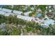 Beautiful aerial view of a friendly neighborhood with mature trees, tennis courts, and a refreshing community pool at 1500 Sunset Rd # G4, Tarpon Springs, FL 34689