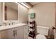 Cozy bathroom featuring a vanity with drawers, open shelving and a toilet at 1500 Sunset Rd # G4, Tarpon Springs, FL 34689