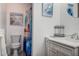 Bright bathroom with a combination of modern fixtures, framed art and vanity at 1500 Sunset Rd # G4, Tarpon Springs, FL 34689