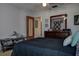 This bedroom features a ceiling fan, wood-trimmed mirror, and decoratively designed throw pillows at 1500 Sunset Rd # G4, Tarpon Springs, FL 34689