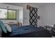 This bedroom features a large window and a black and white tapestry hanging to the right at 1500 Sunset Rd # G4, Tarpon Springs, FL 34689