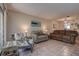 Bright living room with a sofa, chairs, and a sliding glass door to a patio at 1500 Sunset Rd # G4, Tarpon Springs, FL 34689
