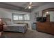 Well-lit main bedroom with large windows, fan and closet, creating an open feel at 1500 Sunset Rd # G4, Tarpon Springs, FL 34689