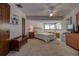 Comfortable main bedroom featuring a ceiling fan, large windows, and soft carpet at 1500 Sunset Rd # G4, Tarpon Springs, FL 34689