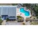 Aerial view of the community pool and surrounding area with lush landscaping and plenty of lounge chairs at 1500 Sunset Rd # G4, Tarpon Springs, FL 34689