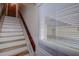 Staircase to living area featuring wood and white painted accents at 1500 Sunset Rd # G4, Tarpon Springs, FL 34689