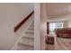 Carpeted staircase leading into a living area with tile flooring and sliding glass doors at 1500 Sunset Rd # G4, Tarpon Springs, FL 34689